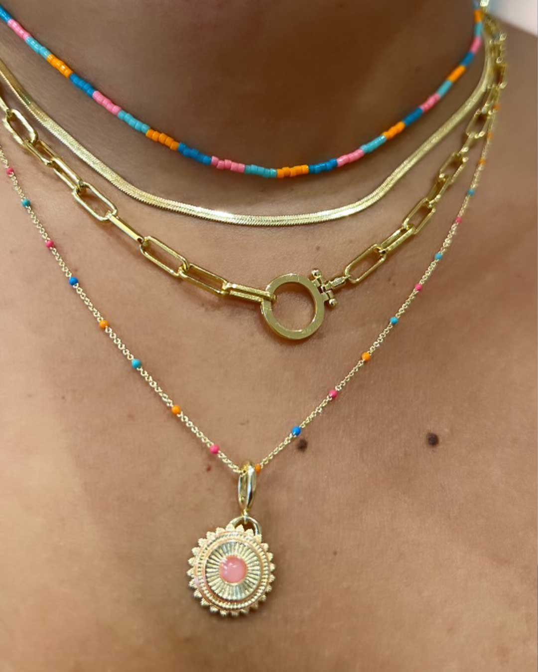 womans necklace stack with colorful statement necklaces