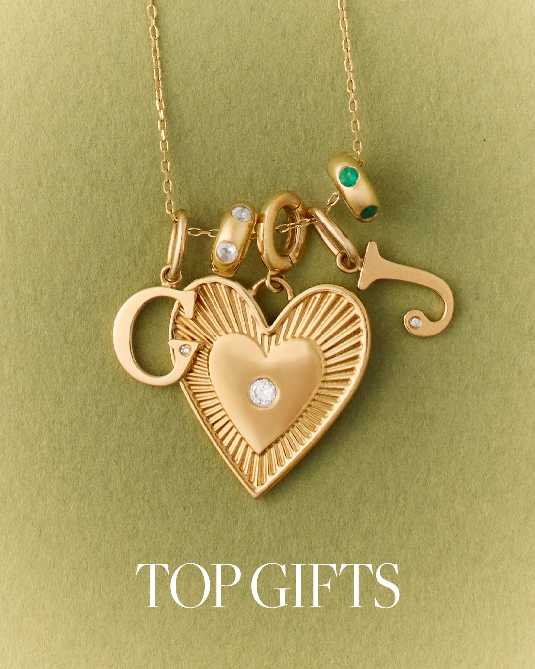Gold necklace with heart-shaped pendant and other charms on a green background. 'TOP GIFTS'