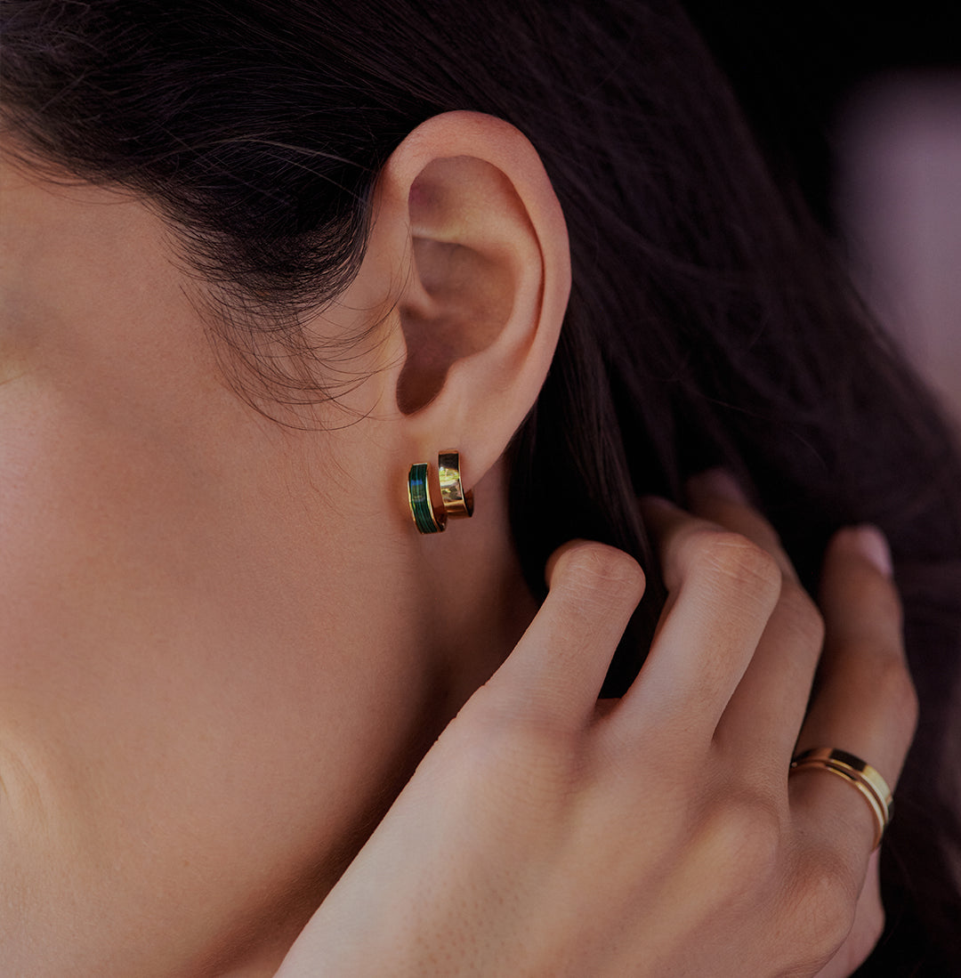 woman wearing two hoop earrings