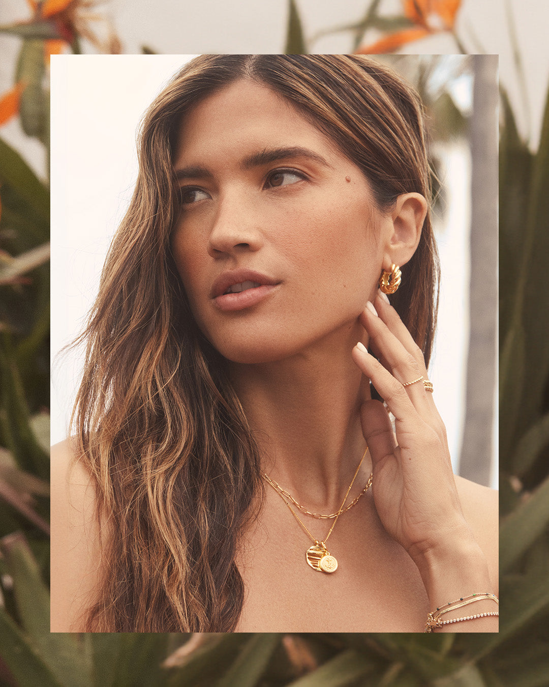 woman in layered gold necklace and bracelets