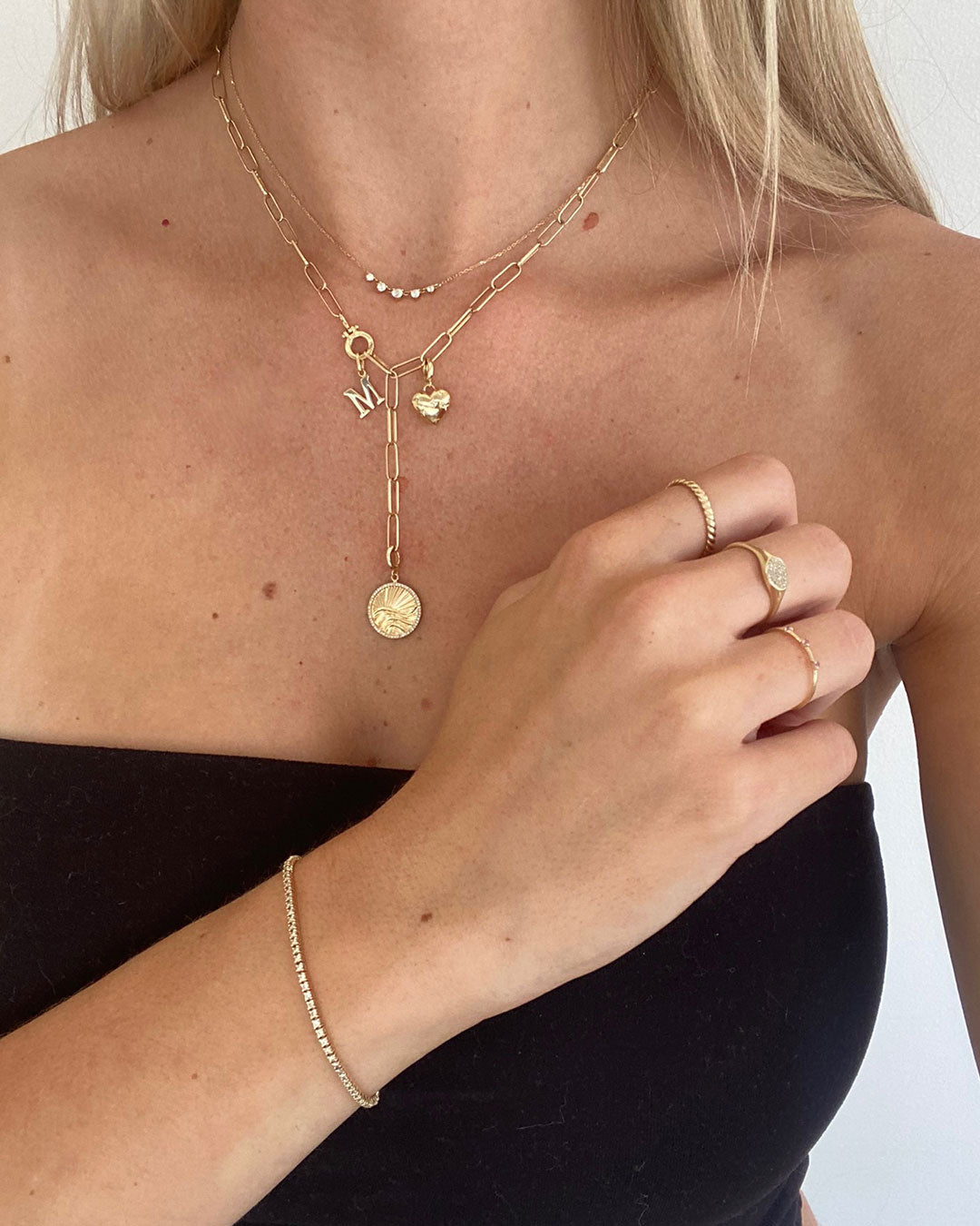 Woman wearing solid necklaces and charms