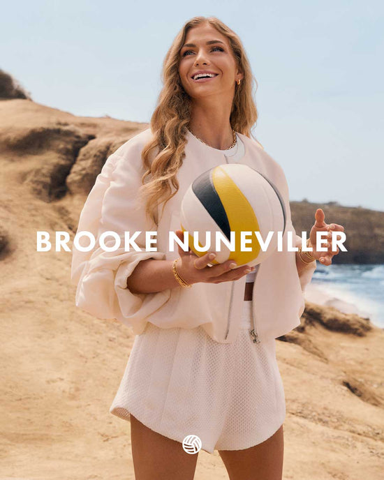 Woman holding a beach ball on a rocky beach with 'Brooke Nuneviller' text overlay.