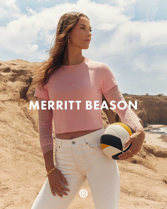 Woman holding a volleyball in a desert setting with 'Merritt Beason' branding.