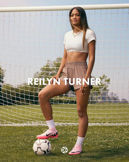 Woman standing on a soccer field with a soccer ball. REILYN TURNER text overlay
