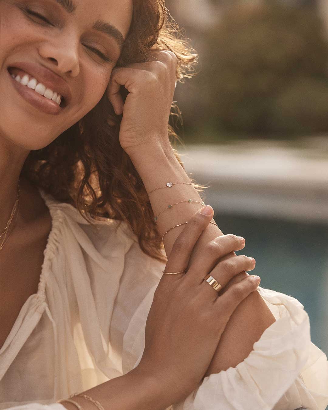 woman wearing gold bracelets and rings