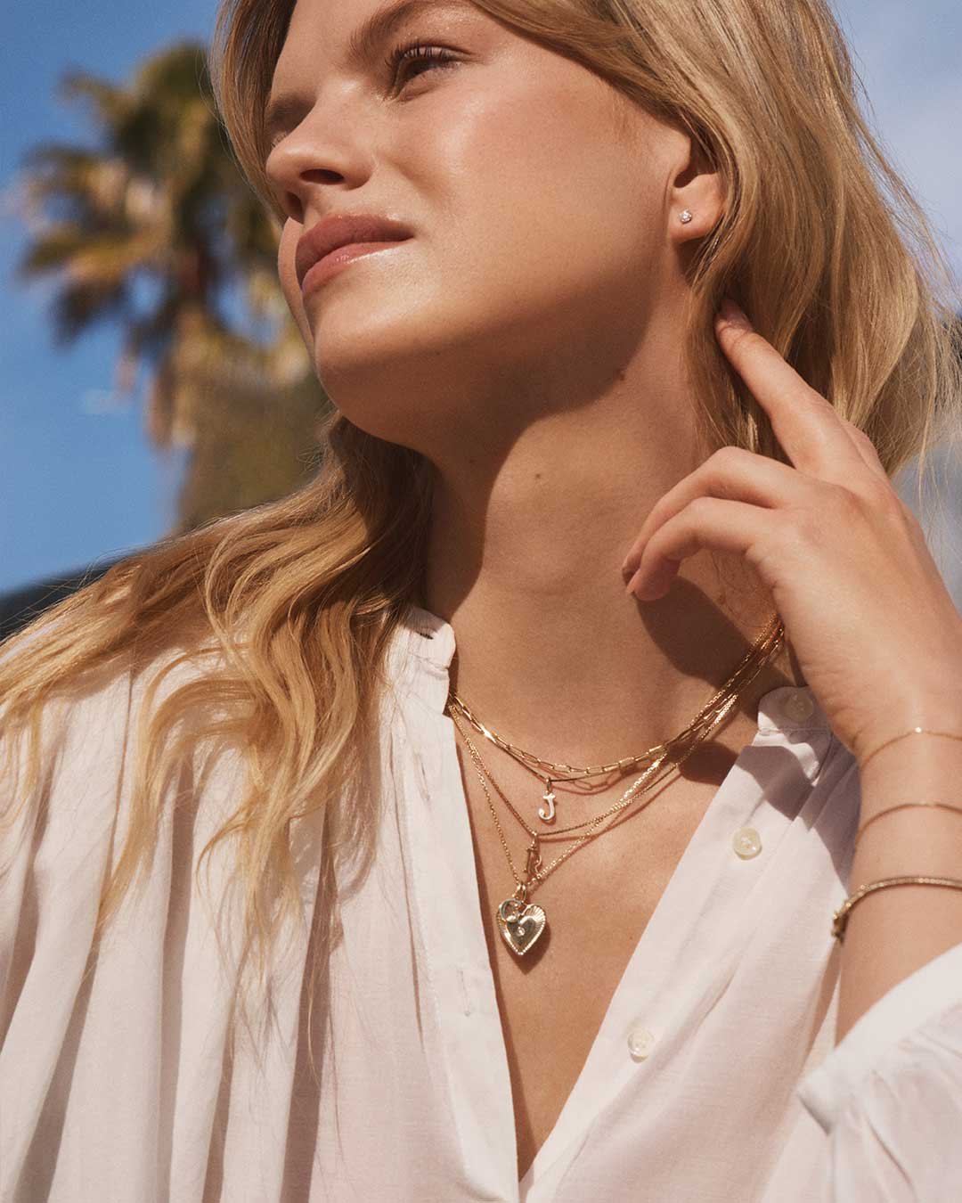 woman wearing 14k gold necklace layers