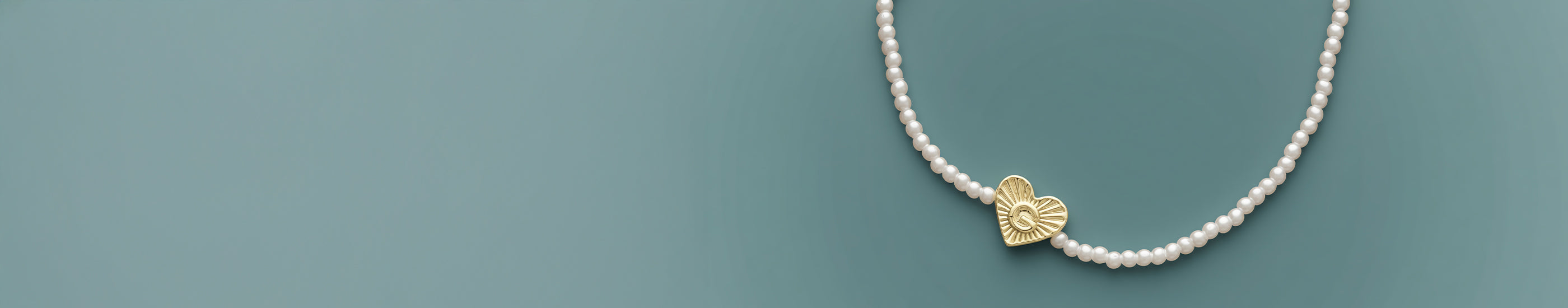 gold plated and pearl bracelet on a blue background 