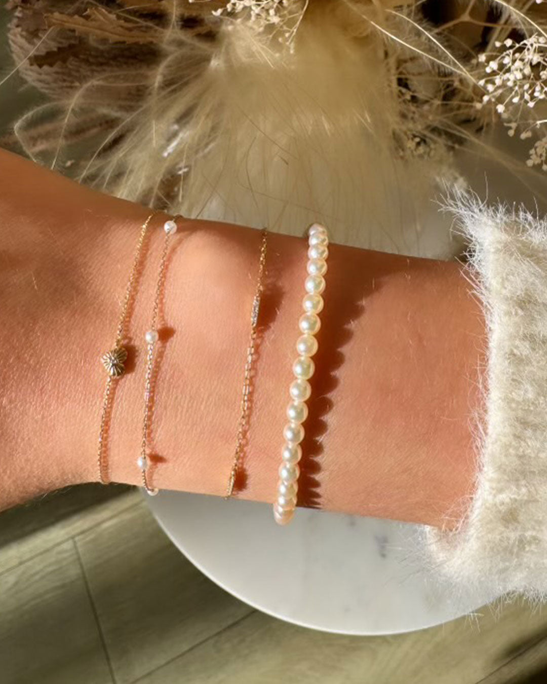 Woman wearing 14k gold and diamond bracelets