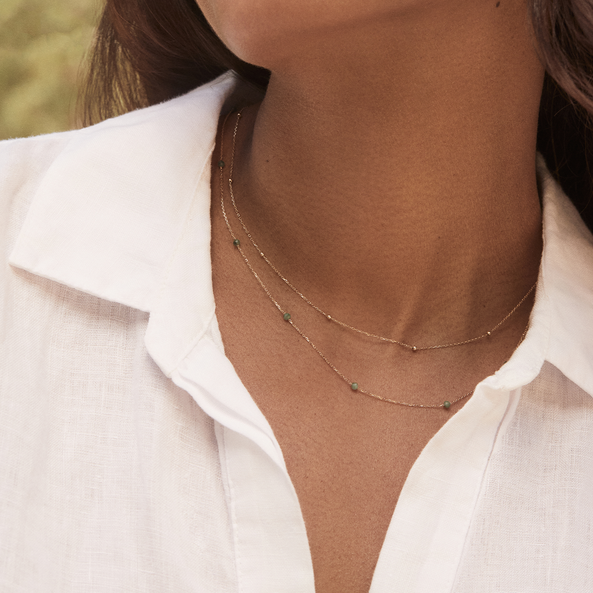 Woman wearing 14k gold newport necklaces. 