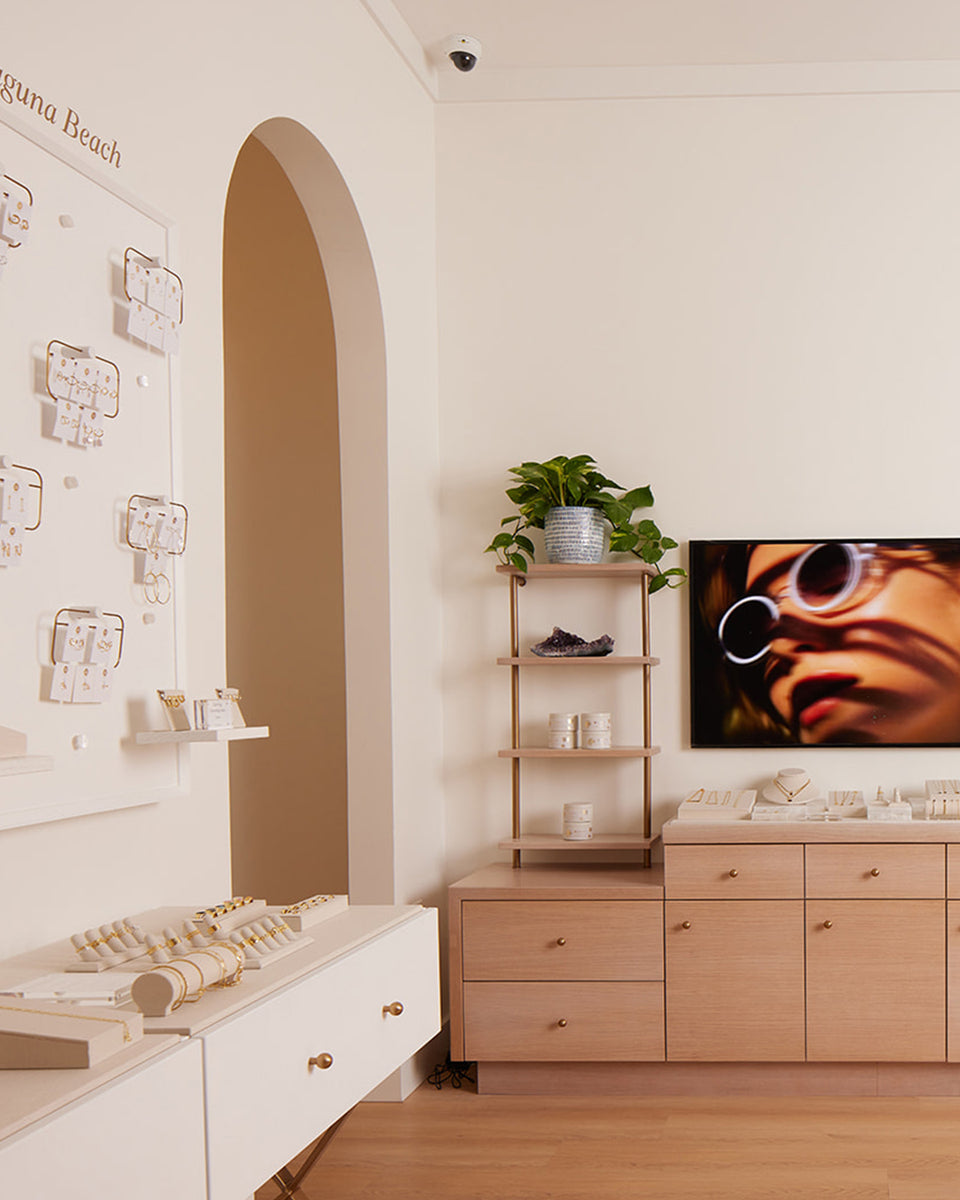 light and bright interior with jewelry pegs on walls with jewelry stands on cases below 