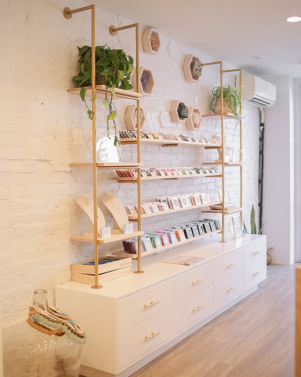 white brick wall with shelving full of jewelry 