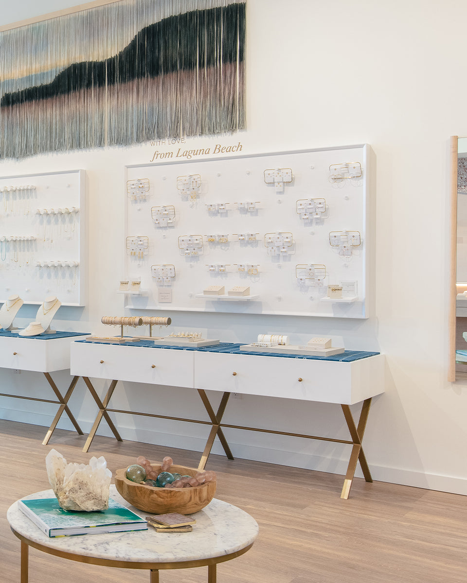 Jewelry on white wall with art piece of ocean scape