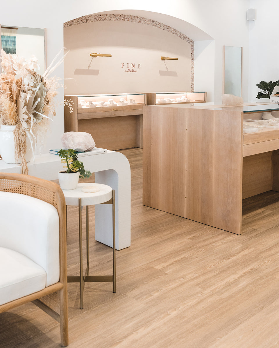 beachy interior of gorjana store with white chair and wood accent