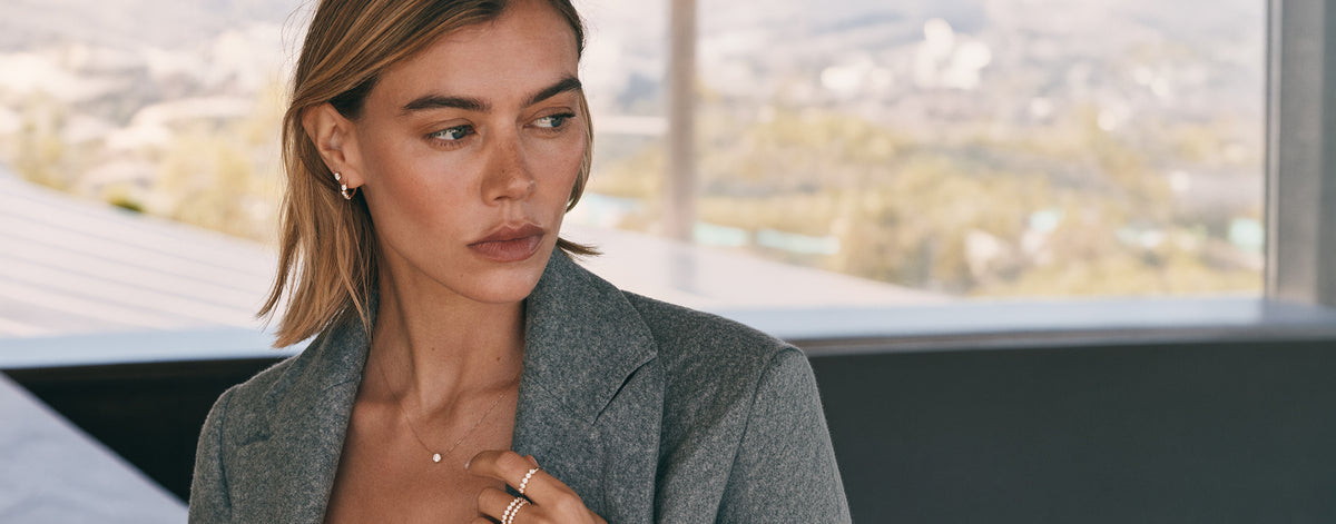 Woman wearing best selling diamond earrings, necklace and rings