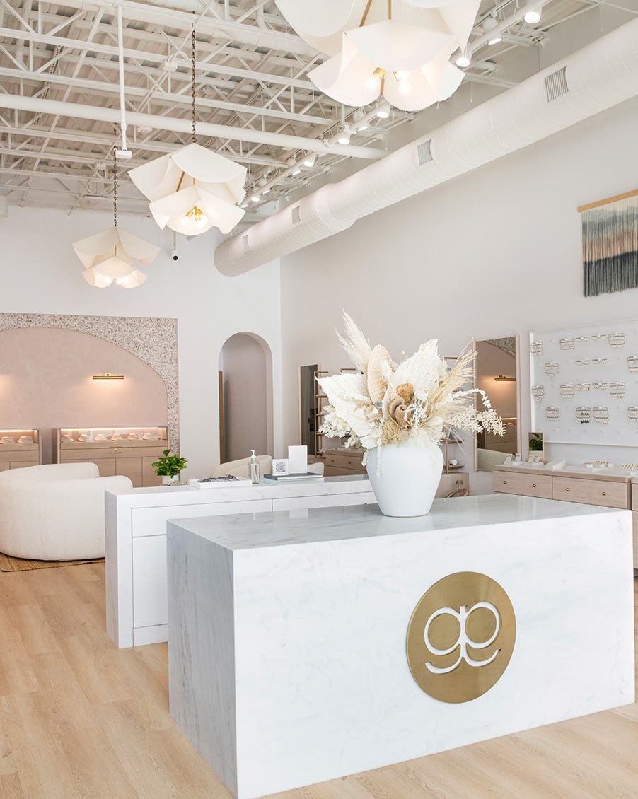 gorjana store interior with white marble counter and white chandeliers 