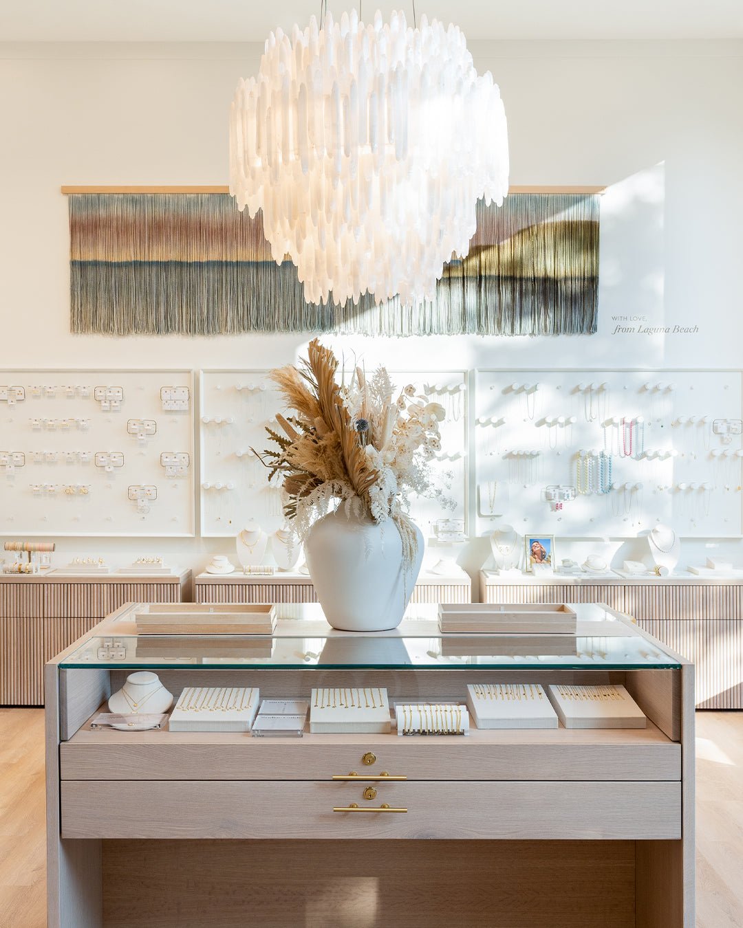 gorjana store interior with jewelry case and white chandelier 