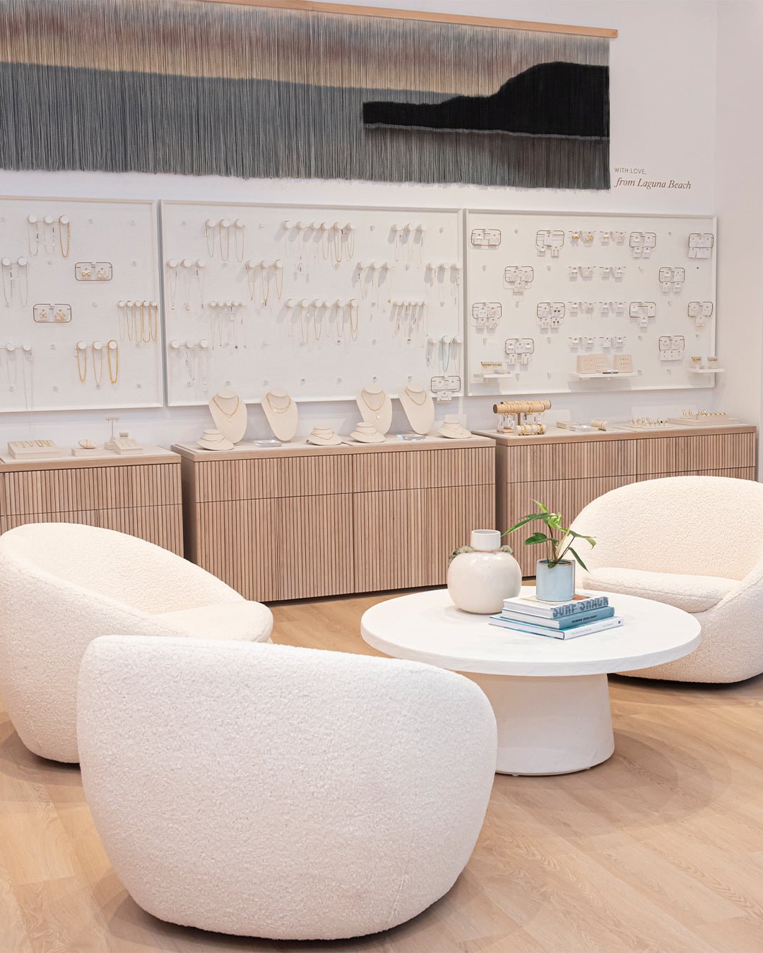 cozy white chairs around a white coffee table in gorjana store