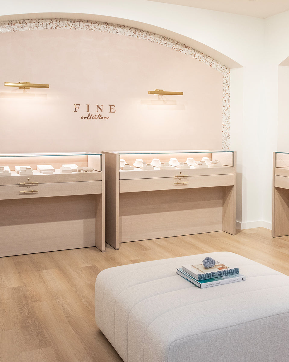 fine jewelry collection inside gorjana store with a big white ottoman 