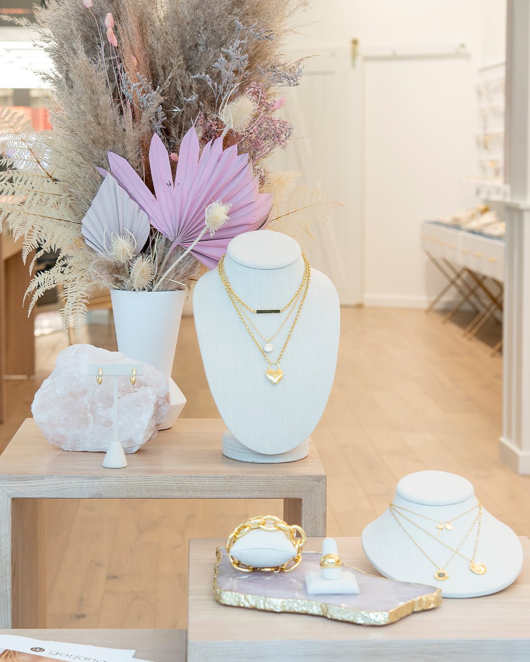 Jewelry stands with necklaces and earrings with a bouquet of boho flowers