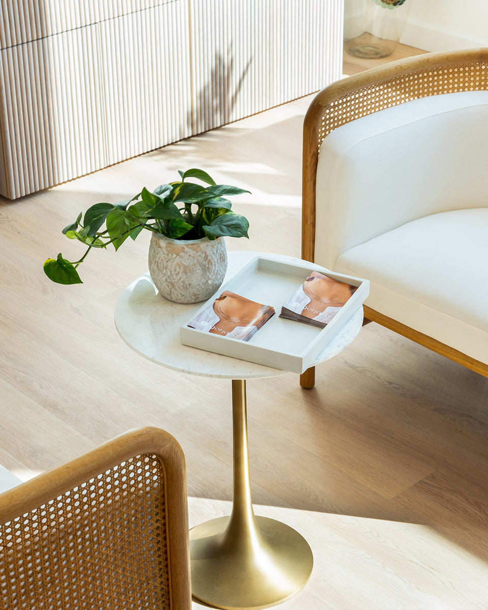 gorjana interior with two chairs and small coffee table with gorjana catalogs 