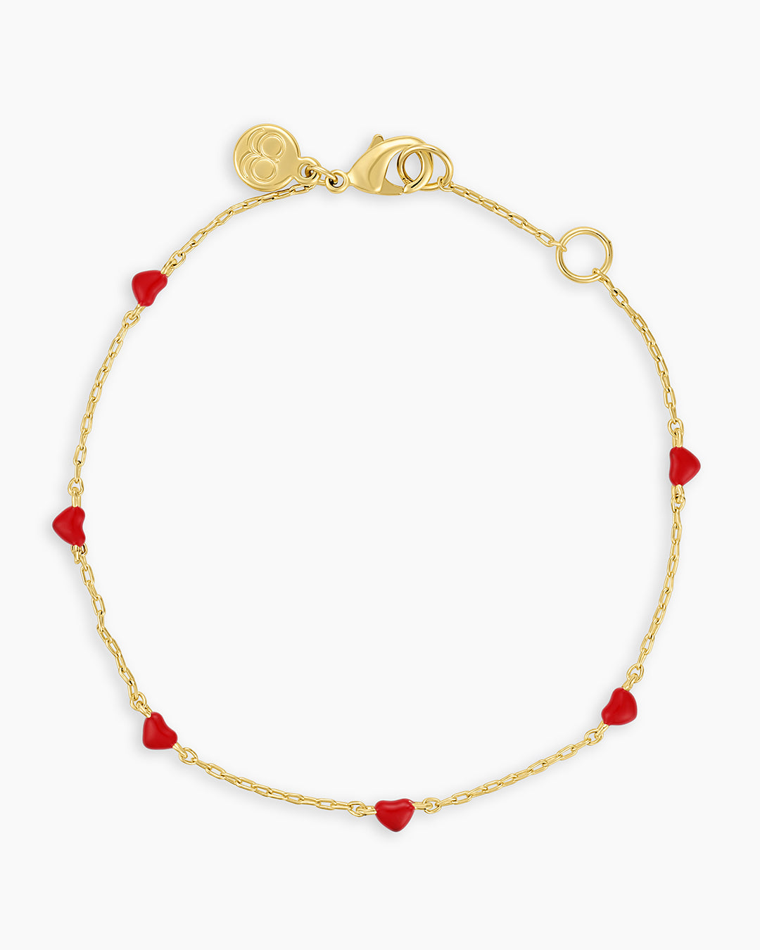 A gold bracelet with red heart charms