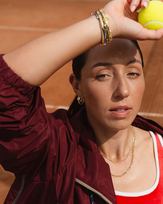 Jessies Pegula wearing bracelets and earrings