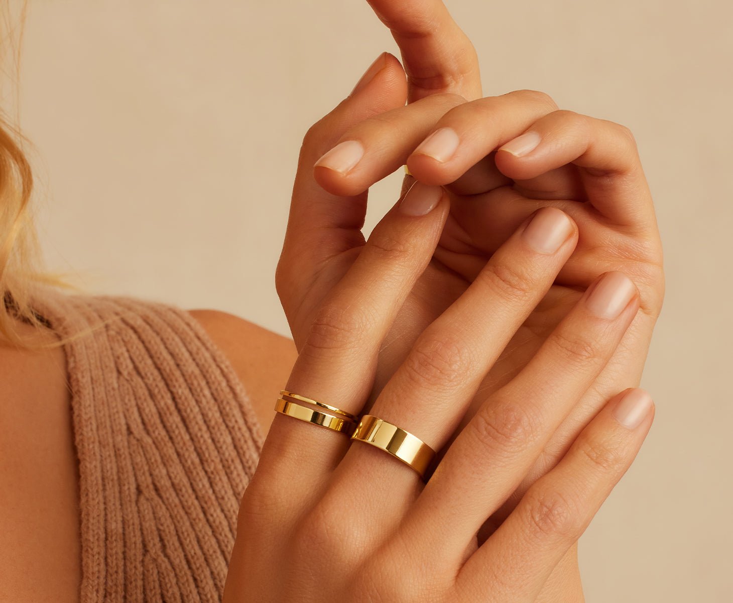woman wearing a gold ring set of 3