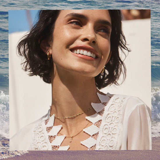 woman in white shirt with gold necklaces