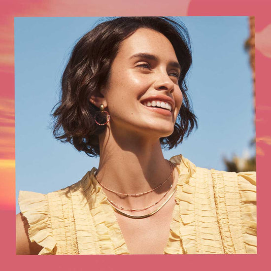 woman in yellow top with necklace stack