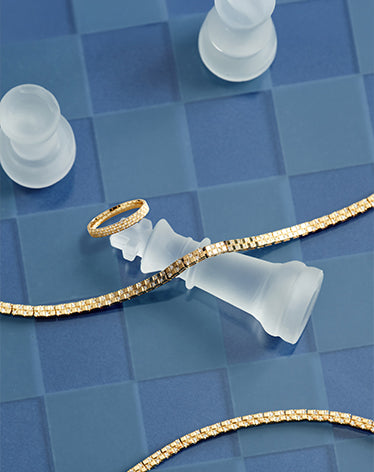glass chess piece and diamond tennis bracelet