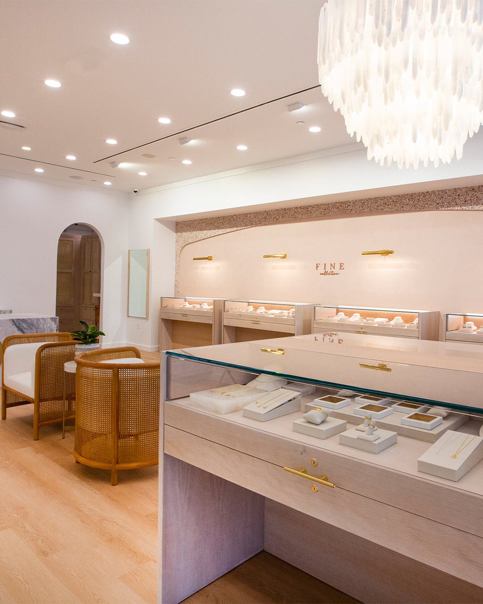 interior of gorjana store with fine jewelry cases and white chandelier 