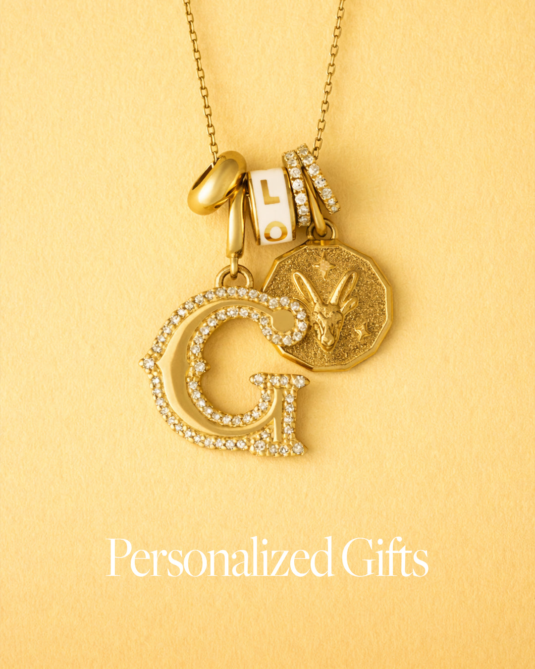 Gold necklace with letter pendants on a yellow background