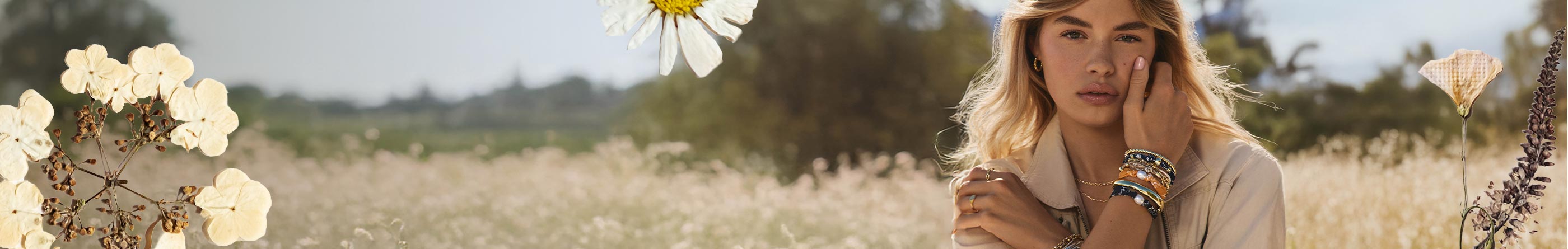 woman in field with jewelry