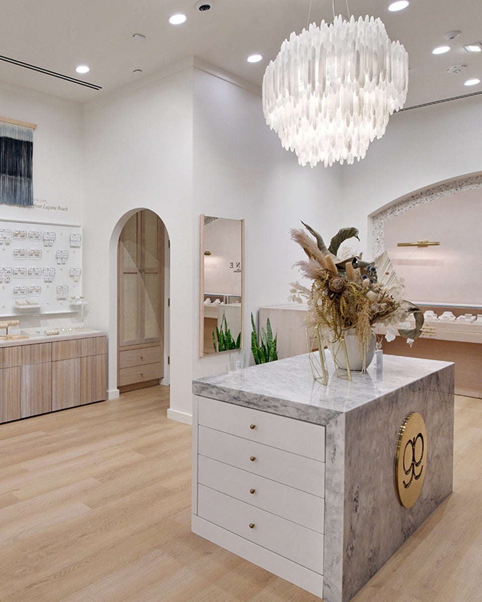 Interior of palm desert with marble island and white chandelier  