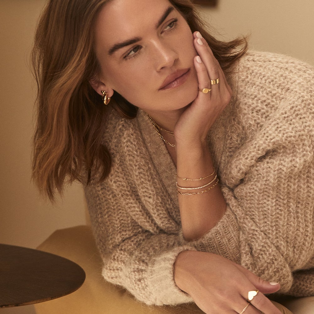 woman wearing earrings, rings and bracelets