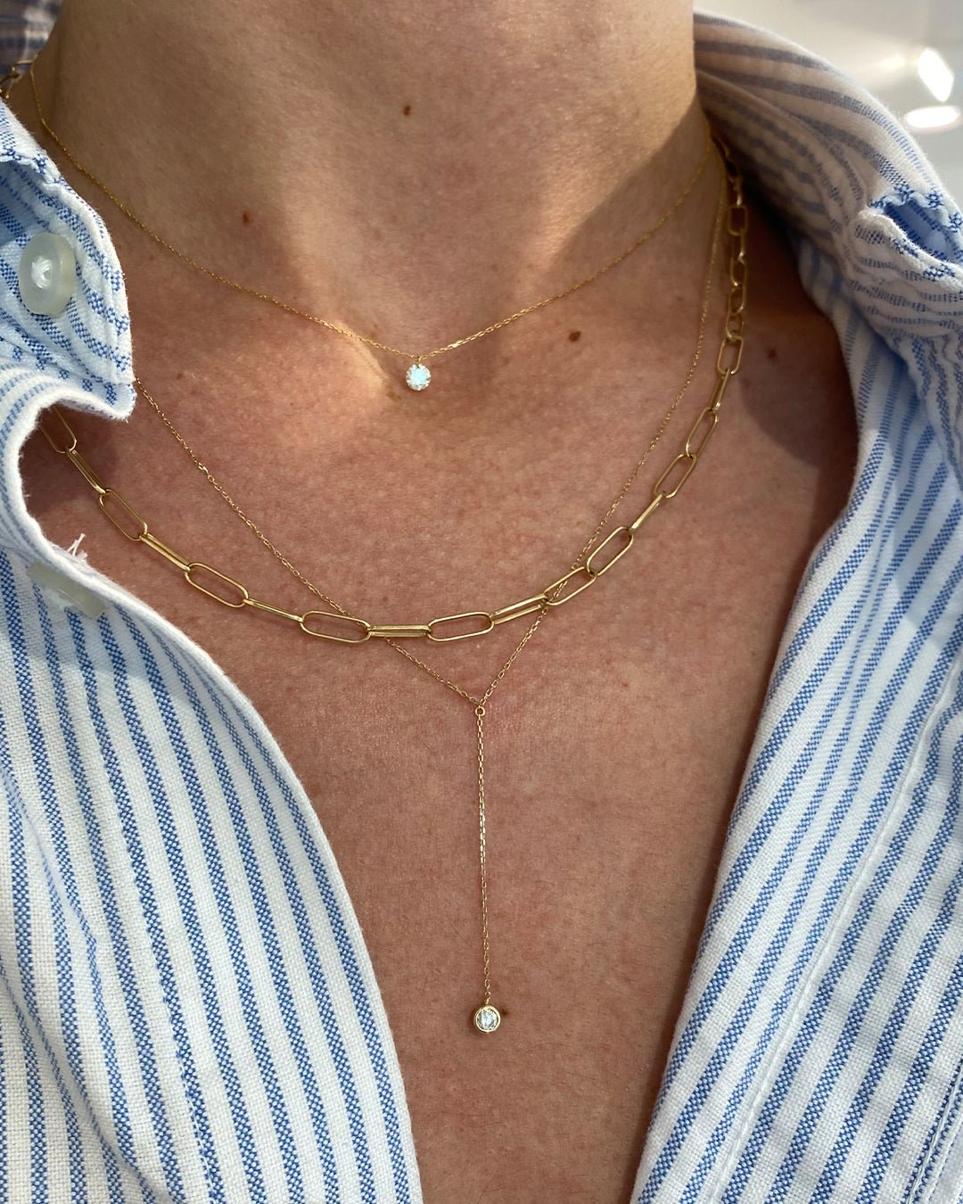 Woman wearing 14k gold and diamond necklaces