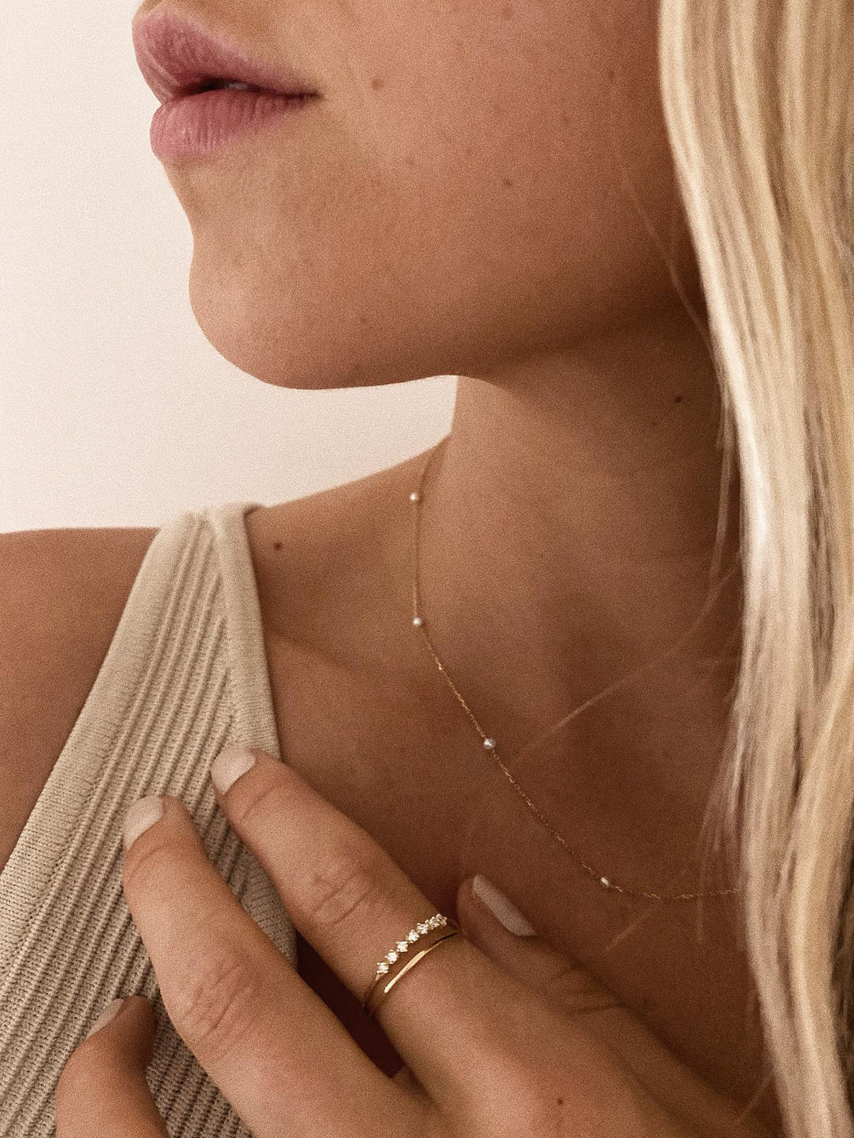 Woman wearing 14k gold ring and diamond ring.