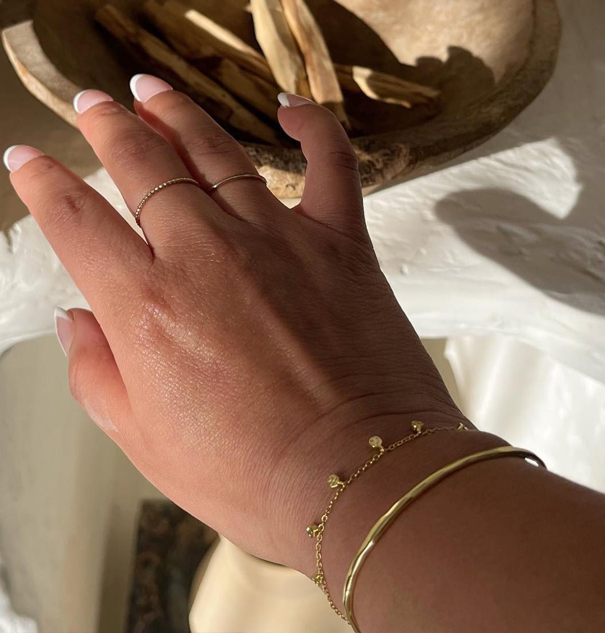 Woman wearing a gold plated bracelet set. 