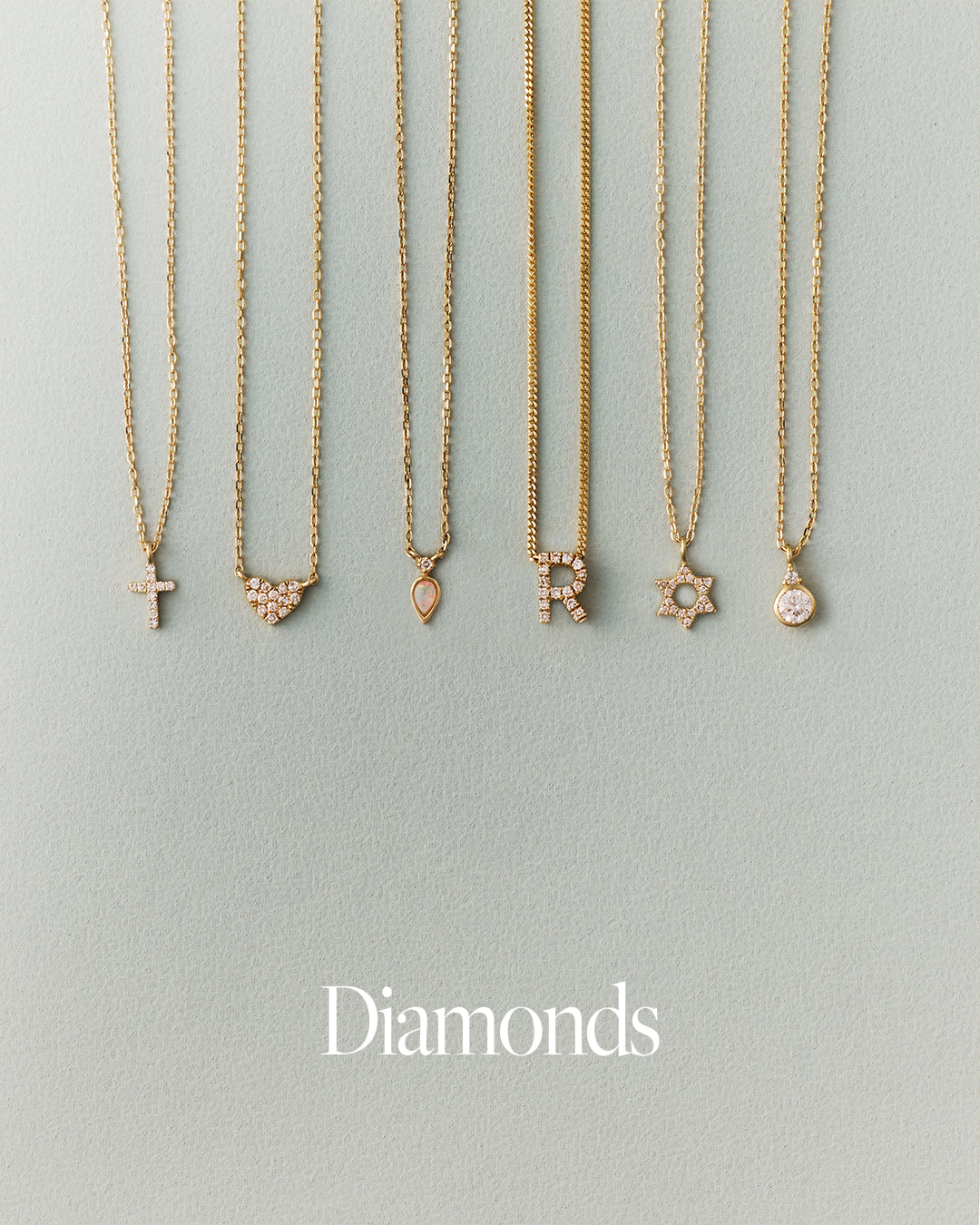 Set of gold necklaces with diamond pendants on a light gray background, 'Diamonds' text