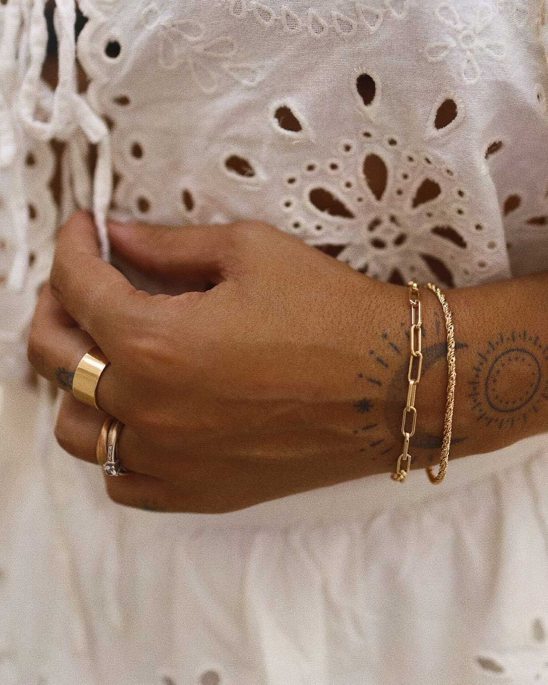 Woman wearing gold plated rings and bracelets
