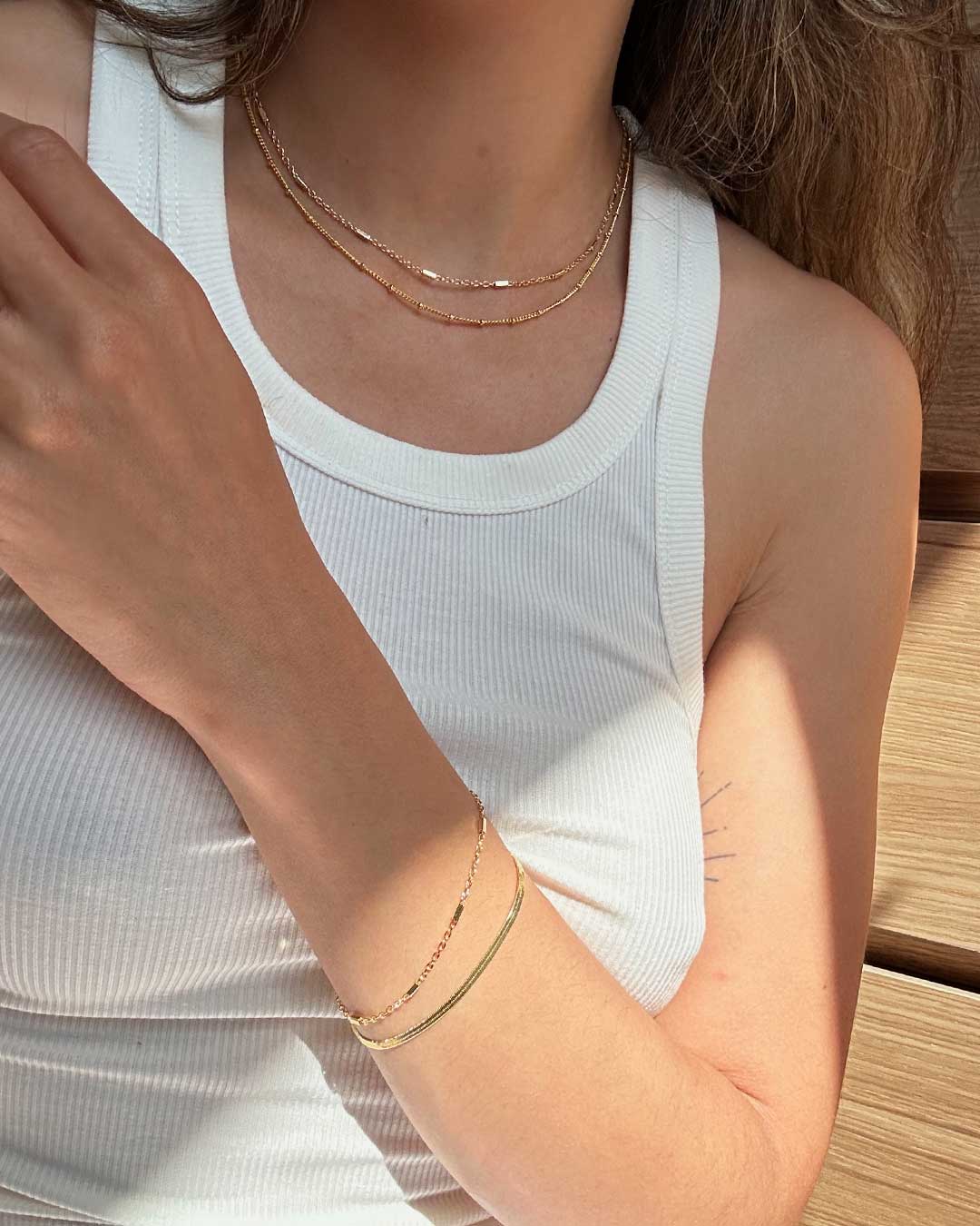 woman in gold necklaces and bracelets