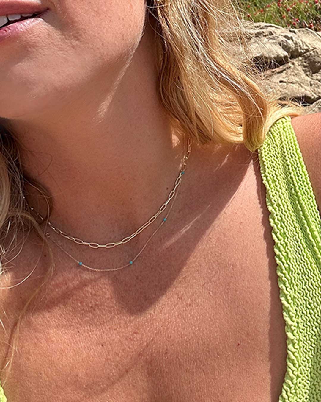 woman in gold necklaces