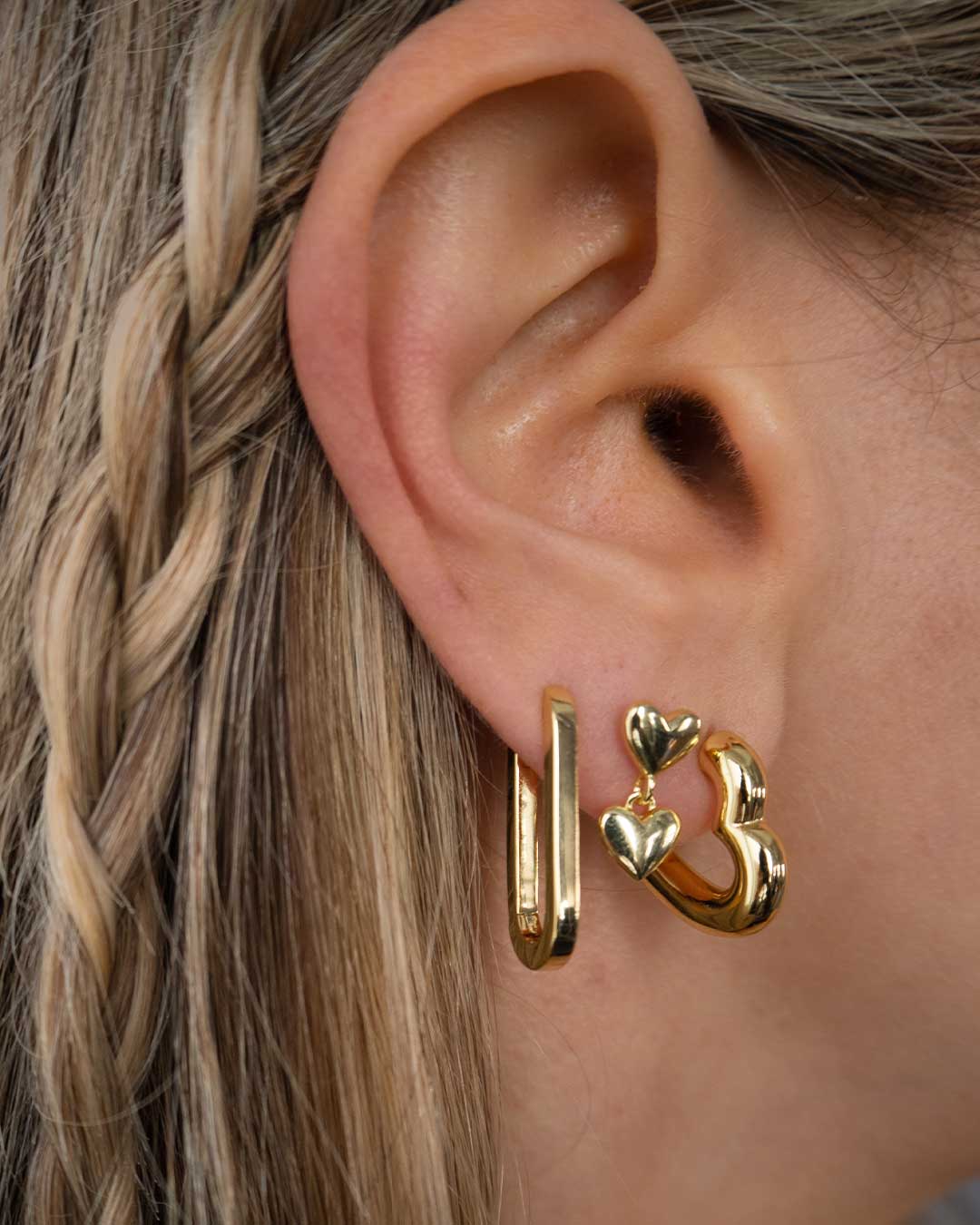 Woman wearing gold plated huggies