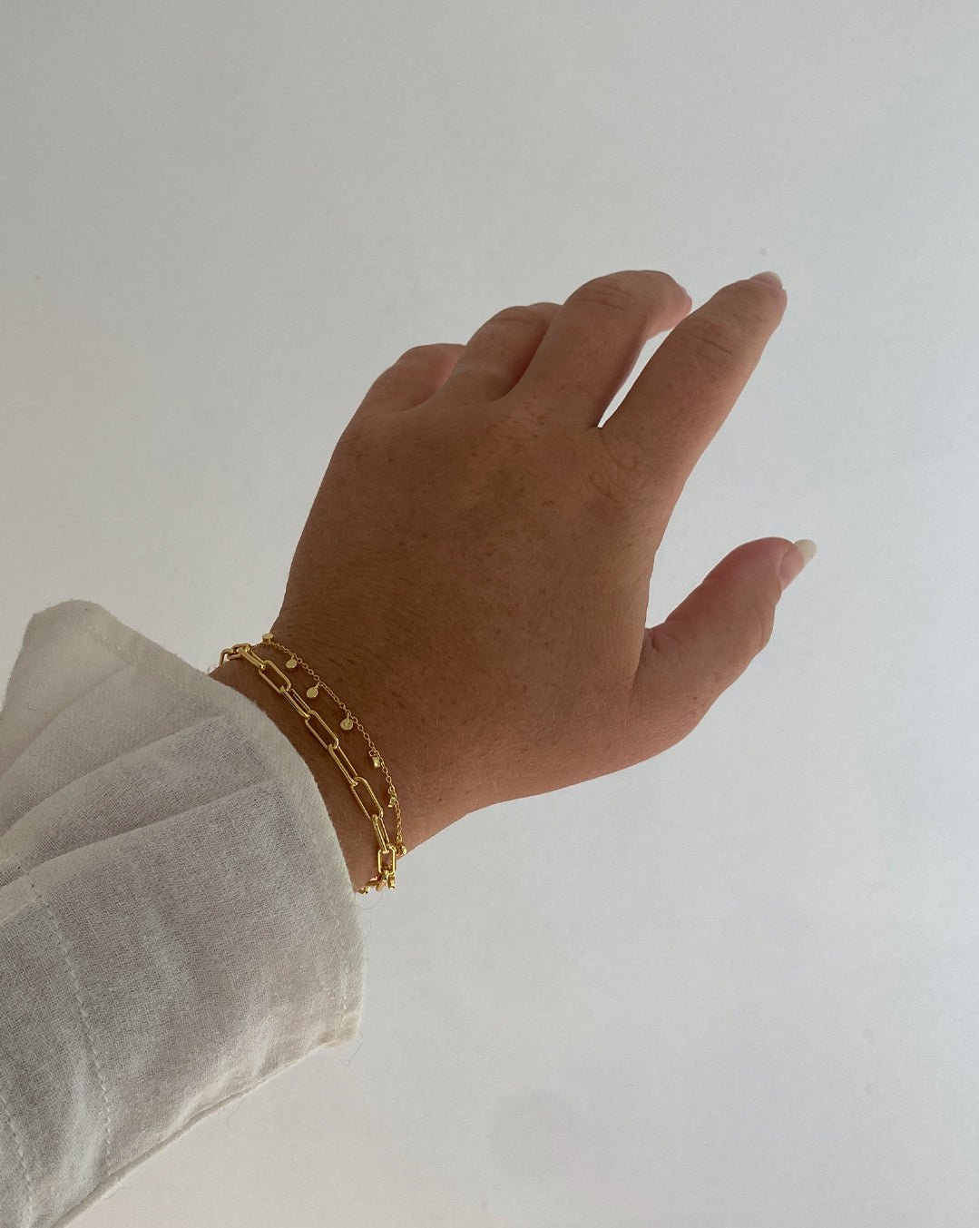 Woman wearing gold plated bracelets
