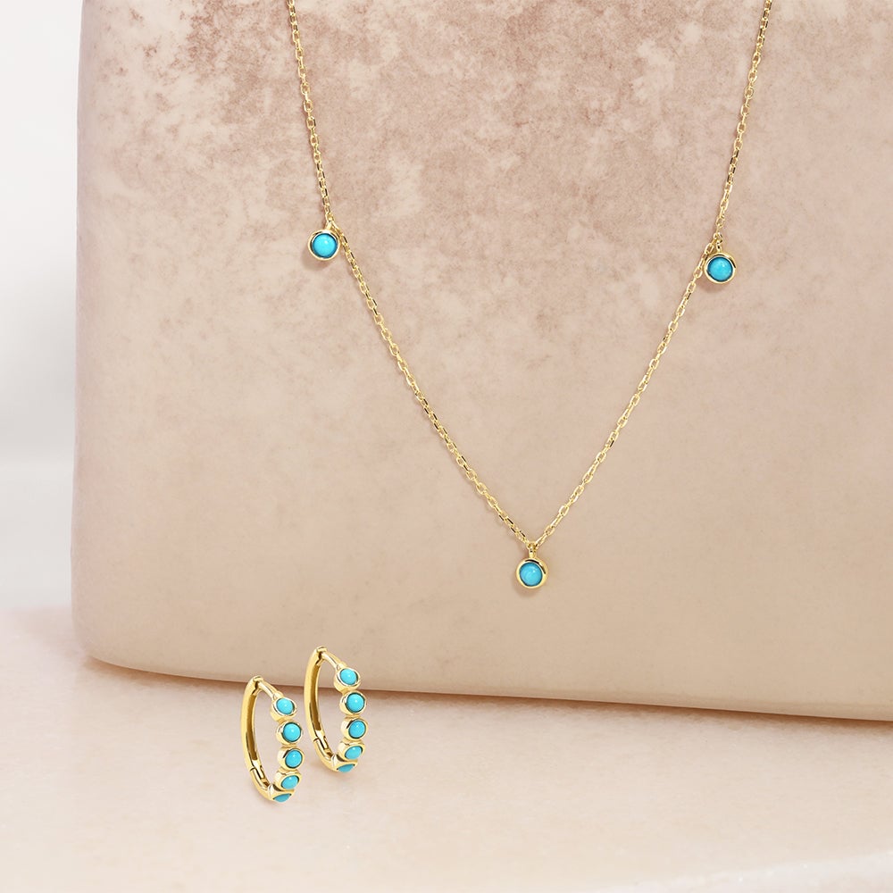 14k gold turquoise huggies and a necklace
