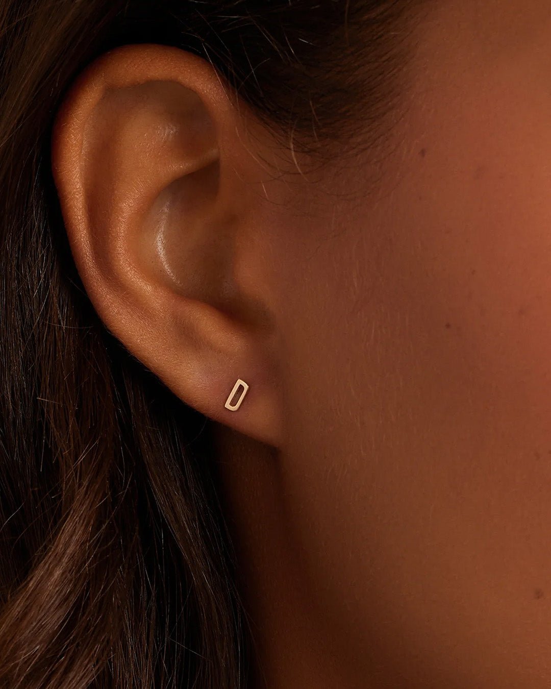 Woman wearing alphabet earring stud || option::14k Solid Gold, D, Single