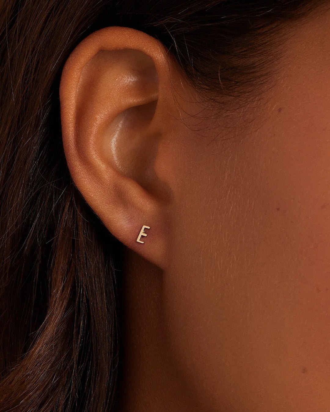 Woman wearing alphabet earring stud || option::14k Solid Gold, E, Single