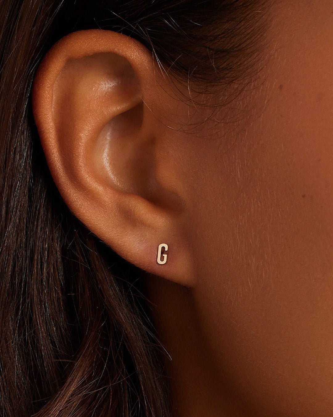 Woman wearing alphabet earring stud || option::14k Solid Gold, G, Single