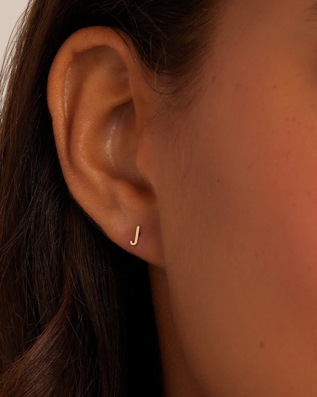 Woman wearing alphabet earring stud || option::14k Solid Gold, J, Single