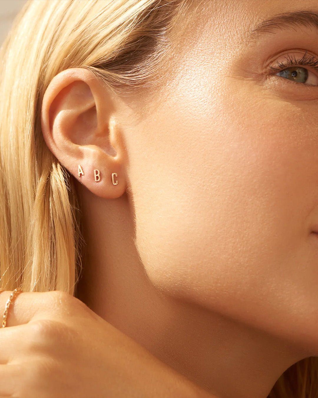 Woman wearing alphabet earring stud || option::14k Solid Gold, J, Single